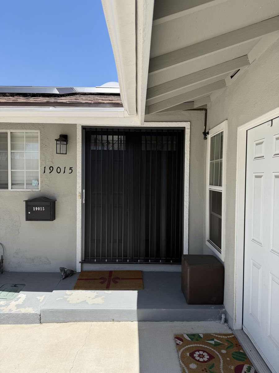 Black folding screen across a wide double front entry