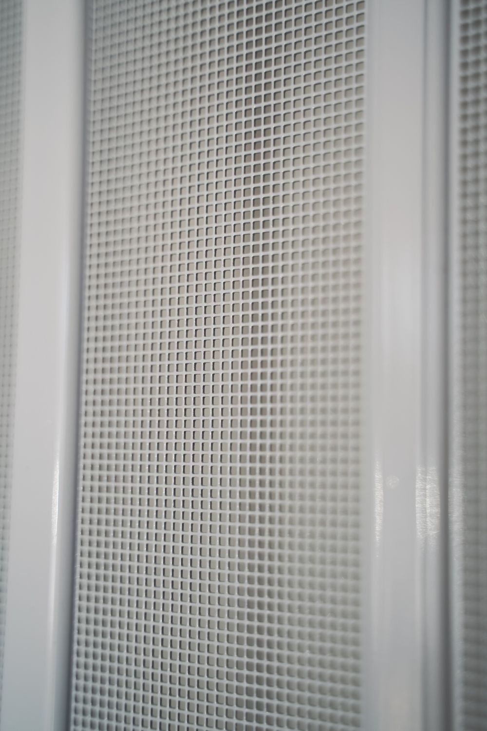 Close-up of the square-weave screen mesh between two pleat strips