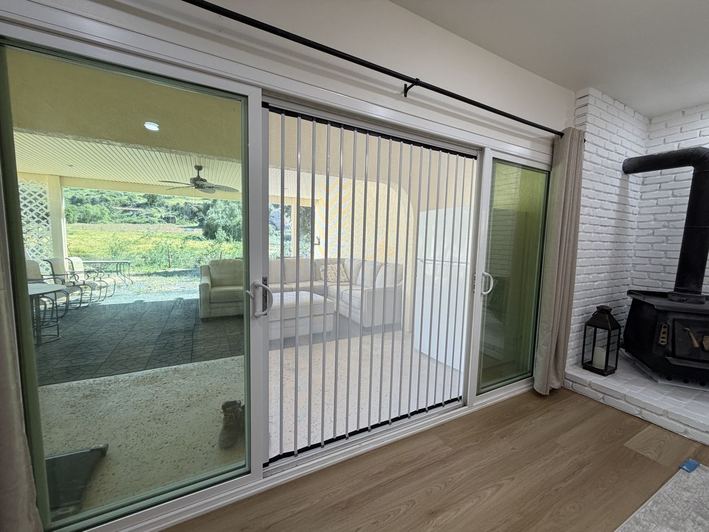 White folding screen in the center panel of a sliding patio door, seen from inside